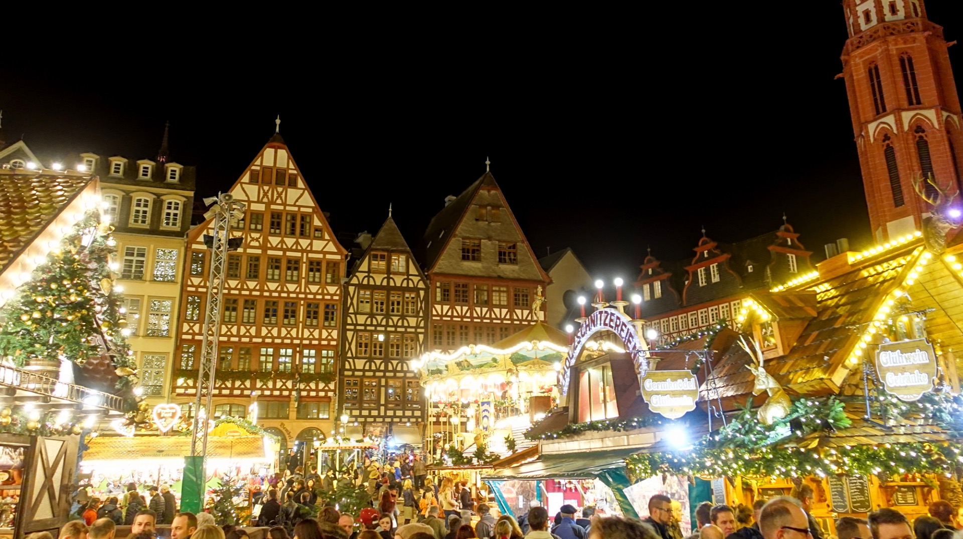 Christkindlmarket holiday market with warm drinks and wooden stalls